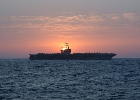 Operation Enduring Freedom, Mar. 6, 2002 — The sun rises behind USS Theodore Roosevelt (CVN-71), as she prepares to turn over operations to the John F. Kennedy (CV-67) Battle Group. U.S. Navy photo by Photographer’s Mate 1st Class Jim Hampshire. [020306-N-6492H-510]. Uss Theodore Roosevelt, Model Warships, Go Navy, Navy Aircraft Carrier, Aircraft Carriers, The Sun Rises, Navy Aircraft, Sun Rises, Dawn And Dusk