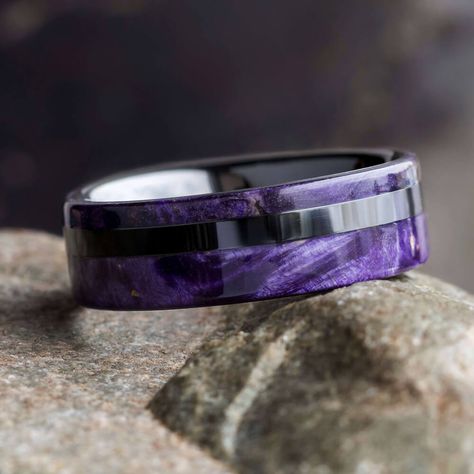 A colorful statement piece, this purple box elder burl wood ring features vivid natural coloring and an interesting wood grain. A ceramic pinstripe and sleeve complements this eco-friendly ring for a comfortable fit and a sleek design. This ring is guaranteed to make a lasting impression. Available as seen or can be customized with any of our other 100+ wood options.This wood wedding band comes with FREE Ring Armor Waterproofing (a $75 value).RING LAYOUT Ring Width: 8 mm Ring Sleeve: Black Ceram Purple Ring Men, Mans Rings, Epoxy Rings, Leather Gauntlets, Interesting Rings, Male Rings, Dragon Wedding, Contemporary Wedding Rings, Blue Wedding Rings