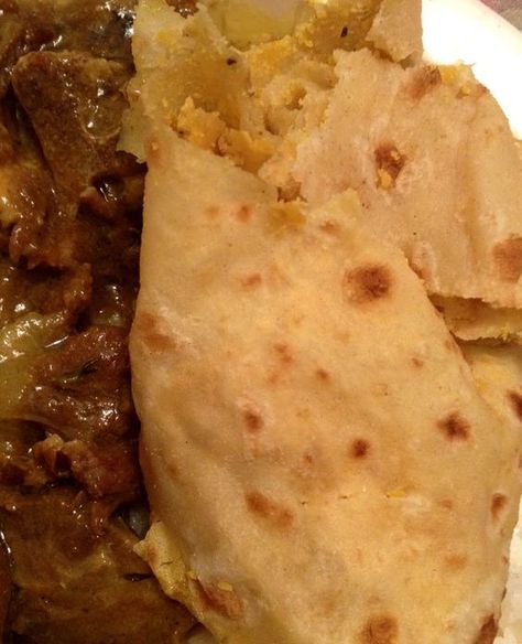 Jamaican Plain Roti Recipe - Roti is a type of bread popular in South Asia as well as the Caribbean. Similar in appearance to a Mexican tortilla, it is made with wheat flour and no leavening. In Jamaica Roti  is often eaten with a filling of Curry Goat or Curry Chicken. Jamaican Cornmeal Porridge Recipe, Cornmeal Porridge Recipes, Seasoned Popcorn, Saltfish Fritters, Cornmeal Porridge, Type Of Bread, Mexican Tortilla, Jamaica Food, Trinidad Recipes