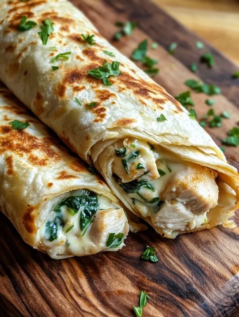 If you’re searching for a dish that embodies comfort and indulgence, look no further than these Cheesy Garlic Chicken Wraps! Imagine tender chicken breast layered with gooey melted cheese, fresh spinach, and a flavorful garlic-infused cream cheese spread, all encased in a soft flour tortilla. Perfect for a quick lunch or a satisfying dinner, these wraps are not only delicious but also i... Ceaser Chicken Pita, Healthy Spinach Wraps, Chicken Feta Wrap, Chicken And Spinach Wraps, Chicken Spinach Wrap Recipes, Chicken Spinach Wrap, Chicken Wraps Recipes, Lunches To Bring To Work, Healthy Wraps For Lunch