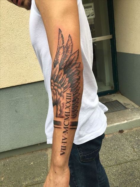 roman-numerals-arm-tattoo-fallen-angel-tattoo-angel-wing-man-with-white-top-jeans Tato Lengan Bawah, Side Arm Tattoos, Wing Tattoos On Back, Wing Tattoo Men, Tattoo Placements, Back Of Arm Tattoo, Tato Dengan Makna, Tato Lengan, Female Tattoos