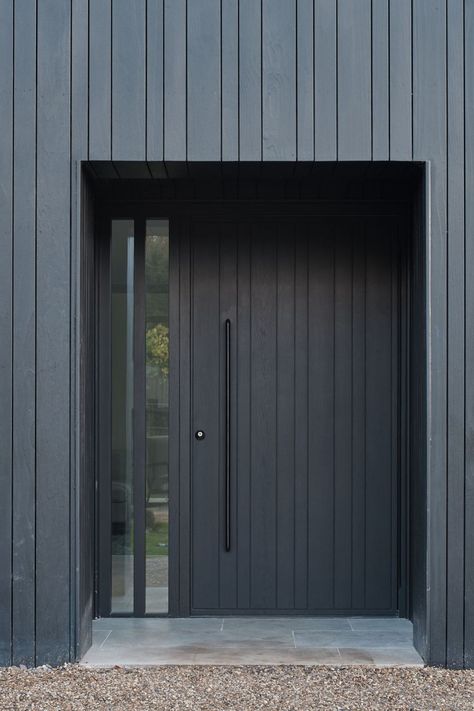 Three unique net zero architect designed homes that embrace the concept of biophilic design all featuring an Urban Front Rondo V in oak with ebony oil, ridged sidelights and black handles. #UrbanFront #doorcouture #madeinbritain #DarkOilFinish #HomeRenovation #InteriorDesign #NetZero #biophilicdesign #ExteriorDesign #ArchitecturalDetails #LuxuryLiving #HomeImprovement #DesignInspiration #StandOutExterior #BeautifulSpace #pivotdoor #doordesign #contemporarydesign #contemporaryarchitecture Urban Front Doors, Modern Cottage Front Door, Black Pivot Front Door, Black Wood Front Door, Modern Front Door Black, Modern Entrance Door Front Entry Home, Outside Door Decor Front Entry, Home Front Door Design, Black Front Door With Sidelights