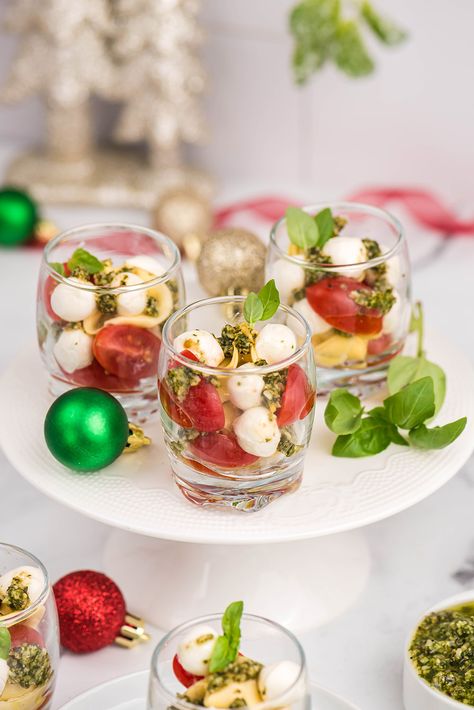 Tomato and mozzarella salad in small glasses for caprese salad shooters. An elegant holiday appetizer or side dish idea. Quick, easy, attractive, and tasty Christmas party food -- or any time of the year!