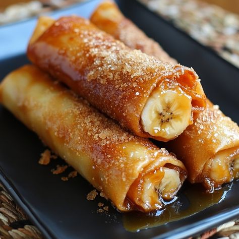 🍌 Satisfy your cravings with Sweet and Savory Banana Turon! A delightful treat with a twist! 🍯 #BananaTuron #SweetAndSavory Sweet and Savory Banana Turon Ingredients: Bananas (3, sliced lengthwise) Spring roll wrappers (12) Brown sugar (1/2 cup) Cheddar cheese (1 cup, grated) Oil (for frying) Instructions: Place a banana slice and cheese on each wrapper. Sprinkle with brown sugar. Roll tightly and seal edges with water. Fry until golden brown. Drain on paper towels. 🍯 Enjoy the crispy and... Spring Roll Wrappers, Cookbook Design, Fried Bananas, Twisted Recipes, Food Receipt, Banana Slice, Trending Recipes, Sweet Delights, Spring Rolls