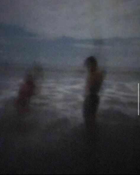 A blurry image of a young couple night swimming on a black sand beach in Ecuador. The grainy aesthetic makes the image look vintage. Surfing At Night, Late Beach Nights, Grunge Beach Pics, Night Blurry Aesthetic, Dark Beach Aesthetic, Swimming In The Dark, Night Beach Aesthetic, Swimming At Night, Gloomy Beach