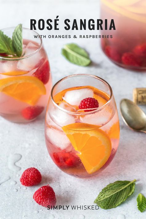 This easy rose sangria recipe is perfect pitcher cocktail for a crowd this summer. It’s made with dry rose, raspberries and oranges and more. Top it with sparkling water before serving. #sangria #rose Cocktail For A Crowd, Simply Whisked, Rosé Sangria, Strawberry Sangria, Cocktail Vodka, Christmas Sangria, Pitcher Cocktails, Easy Rose, Cocktail Gin