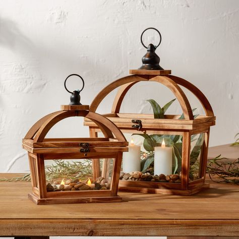 "Find the Tapered Wood Lantern with Open Lid Set, 11\" & 16\" at Michaels. com. Light up your life with something special! Light up your life with something special! Our set of Tapered Wood Lanterns is a unique design that features natural wood grain, modern tapered shape, and a curved open-lid design. An eye-catching metal hanging ring accent adds to its charm. Our lantern is perfect for any home décor style and will instantly make your home look more cozy and inviting. Get ready to enjoy the w Wood Lantern Decor, Wood Lanterns, Floor Lantern, Candle Holder Tray, Tapered Sides, Lantern Craft, Traditional Lanterns, Wood Lantern, Wooden Lanterns