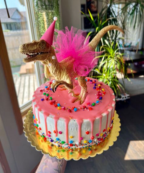 Pink drip cake with gold birthday dino Dinosaur Tutu Cake, Pink Dinasour Birthday Cake, Dinosaur Princess Cake, Pink Dino Birthday Party, Girl 3 Rex Birthday, Dinosaur Birthday Party Pink, Girly Dinosaur Birthday Cake, Dinosaur And Unicorn Cake, Pink Dinosaur Party Cake