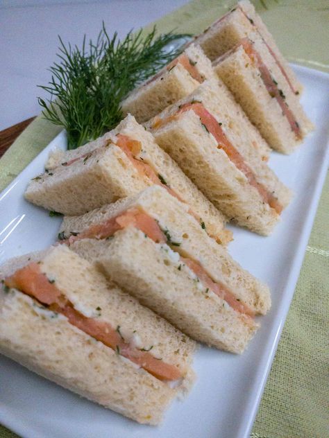 This addicting tea sandwich features a homemade herb butter and delicate smoked salmon. Smoked Salmon And Dill Sandwich, Tea Sandwiches Salmon, Salmon Tea Sandwiches Recipes, Winter Tea Party Sandwiches, Salmon Sandwich Ideas, Smoked Salmon Tea Sandwiches, Salmon Tea Sandwiches, Salmon Sandwich Recipes, Salmon Sandwiches