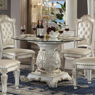 Vendome Dining Table W/Pedestal Base, Antique Pearl Finish The Vendome round dining table looks like it is right out of a Regency photograph. The table is in an antique pearl finish with hand-painted golden paint. The gold paint will help to accentuate the delicate fine details. This table features a decorated single pedestal and a glass tabletop that lets you admire the carved detailing on it. Its compact size is perfect for smaller dining spaces or breakfast nooks. KD, Single Pedestal Table w/ Golden Painting, Acme Furniture, Dining Room Set, Small Dining, Pedestal Table, Dining Table Decor, Gold Paint, Kitchen Dining Furniture, Round Dining