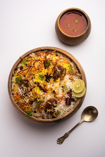 Mutton or lamb biriyani with basmati ric... | Premium Photo #Freepik #photo #mutton-biryani #biryani #basmati-rice #rice-dish Mutton Biryani Photography, Biryani Plating, Biriyani Photos, Biryani Photography, Indian Food Menu, Lamb Biryani, Moody Background, Lamb Rogan Josh, Indian Food Photography