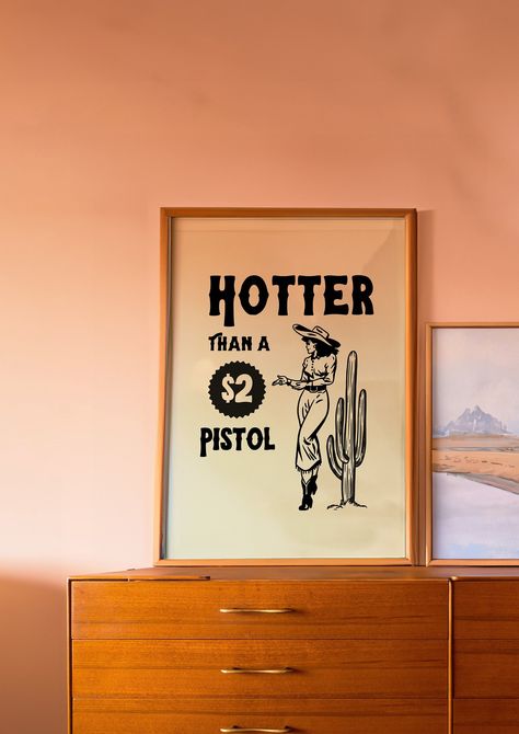 Saddle up and embrace the wild spirit of the open range with our 'Hotter than a 2 dollar pistol' Cowgirl Retro Print. This retro wall art captures the essence of adventure, freedom, and the untamed West. ---------------------------------------------------- Features: Experience art that feels silky to the touch with our high-quality, lighter-weight, classic semi-glossy paper, making it perfect for creating long-lasting prints. We also use FSC-certified paper or equivalent depending on availabilit Retro Western Decor, 70s Western Aesthetic, Western Apartment Decor, Cowgirl Bedroom, Cowgirl Decor, 70s Art, Western Posters, Western Prints, Retro Cowboy