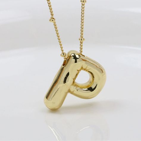 Bubble/Balloon Letter P Initial Necklace Elevate Your Style With Our Very Popular Gold Bubble Initial Necklace. Balloon Letter Pendant On A Delicate Beaded Satellite Chain. Chain Length - 17 1/2- 19 1/2 Inches All Jewelry Comes Beautifully Packaged And Ready For Gift Giving. #Balloon #Bubble #Necklace #Initial #Gold Portugal Outfits, P Necklace, P Initial, Letter Necklace Initials, Balloon Necklace, Bubble Necklace, Gold Bubbles, Holiday List, Bubble Balloons