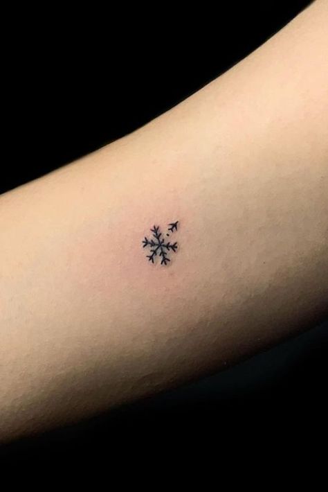 25 Snowflake Tattoo Ideas: Channeling the Beauty of Winter's Delicacy Minimalist Snowflake Tattoo, Tiny Christmas Tattoo, Small Ski Tattoo, Winter Tattoos For Women, Snow Flakes Tattoo, Enjoy The Journey Tattoo, Small Christmas Tattoos, Snowflake Tattoo Design, Snowflakes Tattoo