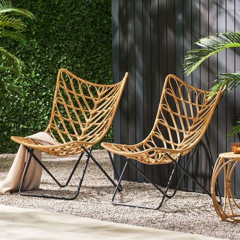 Our 2-piece Patio Accent Chairs set features a wicker finish that provides an earthy boho look for any patio or backyard space. Featuring graceful curves contrasted by clean lines, this set maintains a comfortable and reliable design. Each chair is finished with a geometric cross base, making this modern aesthetic ideal for any style of decor. This isn't merely a chair - it's an open invitation to unwind, reminisce, and create lasting memories under the open sky.