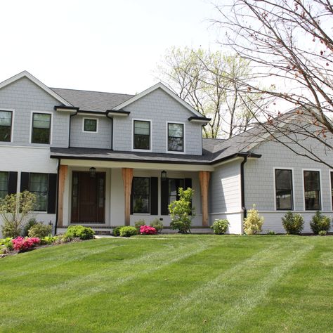 This house has James Hardie Light Mist siding on it with Arctic White trim. The use of straight edge shake siding on the front makes it stand out and look incredible. James Hardie Siding, White Porch, Shake Siding, Hardie Siding, Bungalow Renovation, James Hardie, Siding Colors, Exterior Remodel, House Siding