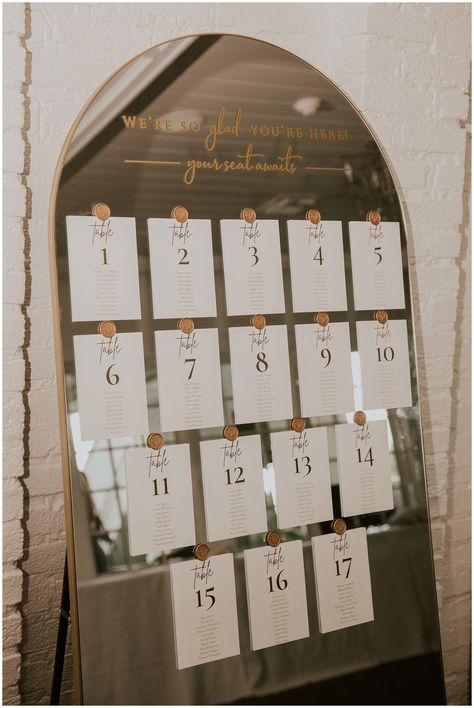 Say hello to your dream wedding seating chart! 👋 This sleek and modern mirror seating chart is the perfect way to add a touch of glam and sophistication to your special day. 🎉 Photo by Sydney Madison Creative Gold Mirror Guest List, Seating Chart Wedding Sayings, Lover Seating Chart, Wedding Seating Chart On Mirror, Find Your Seat Mirror, Seating Chart Sayings, Seating Chart Mirror Wedding, Mirror Seating Chart Wedding Diy, Seating Chart Wedding Ideas Elegant