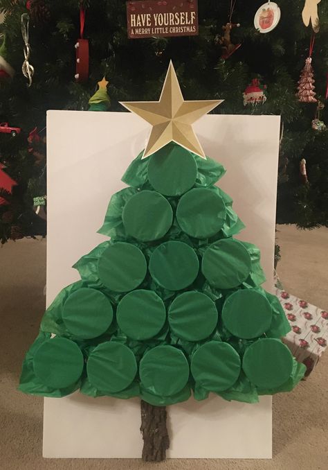 2 pieces of green tissue paper cover the red solo cups to create this tree.  Inside you can place whatever items you want - money, lottery tickets, candy, gift cards, lumps of coal, kids toys, etc.  For the game you can number and let each person pick a number to punch and that keeps the gifts close to the same amount or you can play high low card and whoever gets the highest card gets to punch a cup and keep what is in side.  This can be fun for children and adults of all ages. Money Lottery, Lumps Of Coal, Gift Card Tree, Christmas Tree Game, Pick A Number, Christmas Gift Games, Shop Board, Xmas Games, Green Tissue Paper