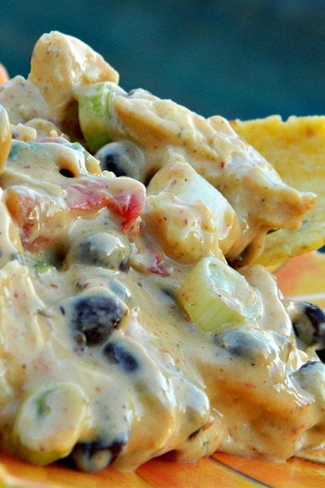 These chicken nachos are a quick and easy nachos recipe! Cook the best nachos using Rotel, Velveeta cheese, chicken breast, sour cream, taco seasoning, jalapeno pepper, and black beans. You will love cooking this nachos recipe for an easy appetizer, finger food, football food, or Super Bowl food. Chicken Nacho Dip Recipe, Warm Chicken Nacho Dip, Chicken Nacho Dip, Nachos Dip Recipe, Nacho Dip, Chips Dip, Cheesecake Dip, Chicken Nachos, Cooking Chicken To Shred