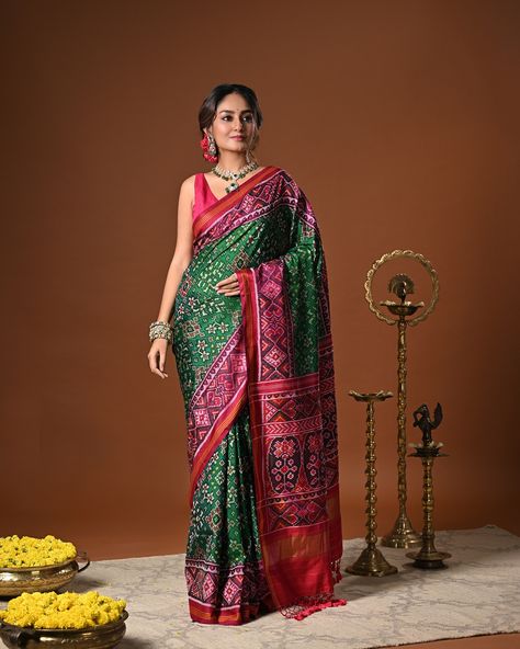 PRICE 36,000 Drenched in vibrant shades, this Handloom Green and Pink pure mulberry silk ikat patola saree shows grace and refinement. Handwoven by master artisans using the single ikat technique, the saree features intricate Navratna motifs accentuated by a striking Pink border. Note: The saree comes with an unstitched blouse piece. Color - Green And Pink Fabric - Mulberry Silk Technique - Single Ikat / Patola Weaving Cluster - Gujarat Saree Measurement - Length - 5.4 m, Width - 45 inche... Silk Ikat, Measurement Length, Pink Fabric, Blouse Piece, Mulberry Silk, Hand Weaving, Saree, Silk, Pure Products