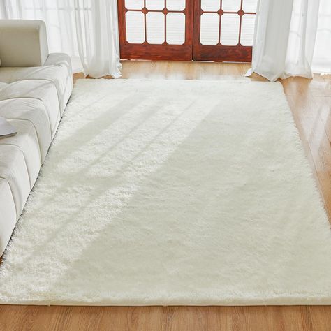 PRICES MAY VARY. HIGH QUALITY MATERIAL - The Velvet Shag rug has a shaggy surface and is extremely soft, made from durable synthetic microfibre with a tight weave that ensures the rug will not fall off easily and the edges will not unravel. Our Grey Fluffy Shag Area Rug with a high density sponge underlay, it makes you feel like you are walking on clouds. The Shaggy Carpets Fuzzy Rug is an excellent choice for family gatherings. IMPROVED NON-SLIP BOTTOM - Modern Pom Pom Rugs have a high-density, Pom Pom Rugs, Fluffy Carpet, Fuzzy Rug, Fur Rugs, Soft Shag, Carpets For Kids, Pom Pom Rug, Modern Style Design, Faux Fur Rug