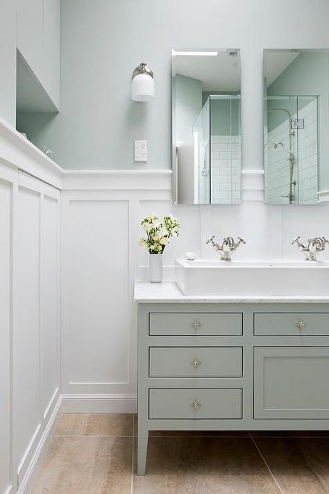 Soothing bathroom features top half of walls painted green and lower half of walls clad in board ... Wainscoting Bathroom, Bad Inspiration, Transitional Bathroom, Hall Bathroom, Bad Design, Upstairs Bathrooms, Bathroom Redo, Bathroom Renos, House Bathroom