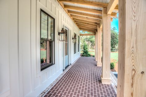 love this porch, brick floor,timbers, black windows, board and batten Farmhouse Front Porch Decor, Outdoor Porch Lights, Wall Lights Outdoor, Board And Batten Exterior, Exposed Rafters, Exterior Light Fixtures, Farmhouse Front Porches, Farmhouse Front, Farmhouse Exterior