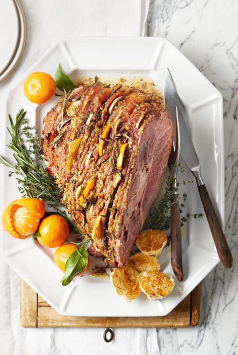 Sure you've stuffed chicken and turkeys, but have you ever stuffed a full ham? Now's the time! Sliced citrus, garlic, and fresh herbs steam in flavor as the spiral sliced ham bakes. #recipeideas #recipes #ham #easterham #bhg Easy Christmas Dinner Menu, Traditional Christmas Dinner Menu, Christmas Eve Dinner Menu, Easter Dinner Menus, Spiral Sliced Ham, Traditional Christmas Dinner, Easter Ham, Easter Side Dishes, Spiral Ham