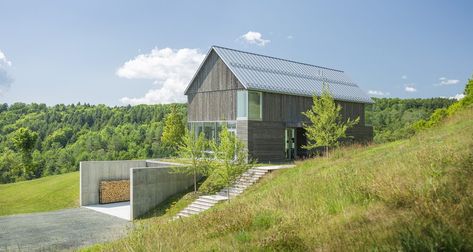 With that in mind, the architects came up with a barn house design that takes advantage of the sloping land in a really cool way. Bank Barn, Concrete Retaining Walls, Cedar Siding, Storey Homes, Environmental Design, A Hill, House On A Hill, Green Roof, Residential Architecture