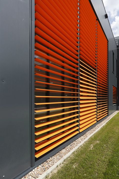 Bright red exterior louvres fitted to a commercial building Modern Aesthetic, Sustainable Materials, Energy Efficiency, Low Maintenance, Sustainability, Louvre, Solar, Sleek, Energy