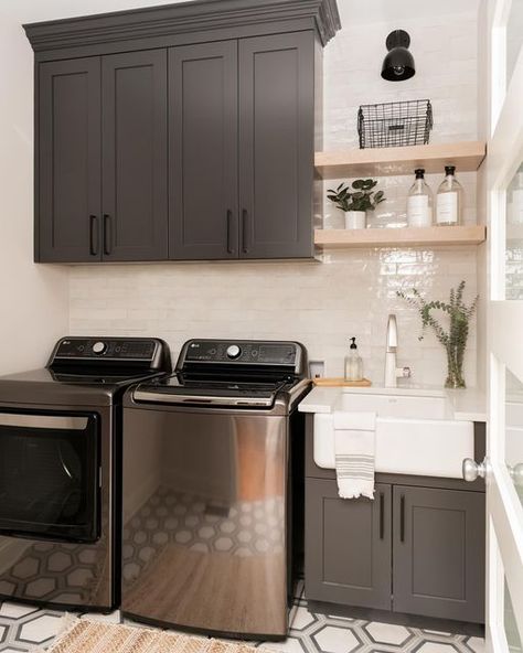 Katie | K. Sneed Design on Instagram: "post-vacation laundry day✨ the worst part about coming home from a trip is definitely unpacking and having to do laundry!! it’s even worse because we just came from 85 degrees to chilly weather in Nashville! This is another laundry room renovation that was just completed with a pretty dramatic transformation!! Swipe to see the before➡️" Brown Laundry Room Cabinets, Grey And Black Laundry Room, Black Laundry Cabinets, Dark Laundry Room Cabinets, Iron Ore Cabinets Laundry Room, Charcoal Washer And Dryer Laundry Rooms, Dark Cabinet Laundry Room, Graphite Laundry Room, Beige Cabinets Laundry Room