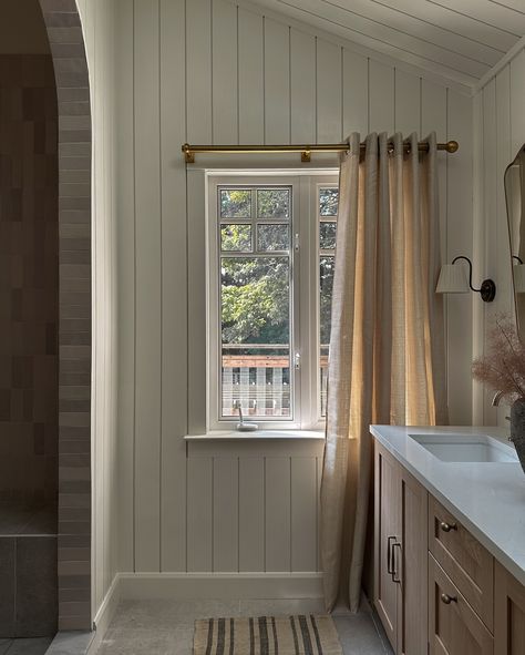 Your morning rituals with an upgrade. ✨ The existing primary ensuite in our client’s home lacked storage, had a cramped shower, and even walls that didn’t reach the ceiling! 😳 This timeless design makes the ensuite feel more spacious and functional with a double vanity, tall vaulted ceilings, shiplap cladding, and an extended shower. . . . . . . . #torontointeriordesigner #architecturaldigest #houseandhome #domino Shower Across From Vanity, Vaulted Ceiling Master Suite, Vaulted Ceiling Bathroom, Bathroom Vaulted Ceiling, Vertical Shiplap Bathroom, Bathroom Wall Paneling, Shiplap Interior, Primary Ensuite, Vaulted Ceiling Beams