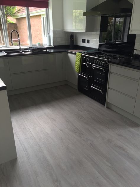 Kitchen floor finally done moduleo classic oak love the new white/pewter high gloss units black work tops and grey floor wickes kitchens Kitchen With Grey Vinyl Floor, Kitchen Remodel With Grey Floors, Grey Floor Kitchen Ideas, Black Kitchen Floor Tiles, Houses Renovation, Kitchen Cabinets With Black Appliances, Oak Floor Kitchen, Grey Floors, Secret Basement