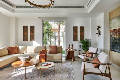 This Dubai Villa Offers an Artful Take on Tropical Modernism Room Decor Orange, Living Room Decor Orange, Tropical Modernism, Gubi Chair, Dubai Villa, White Staircase, Cozy Living Room Ideas, Vibrant Living Room, Urban Habitat