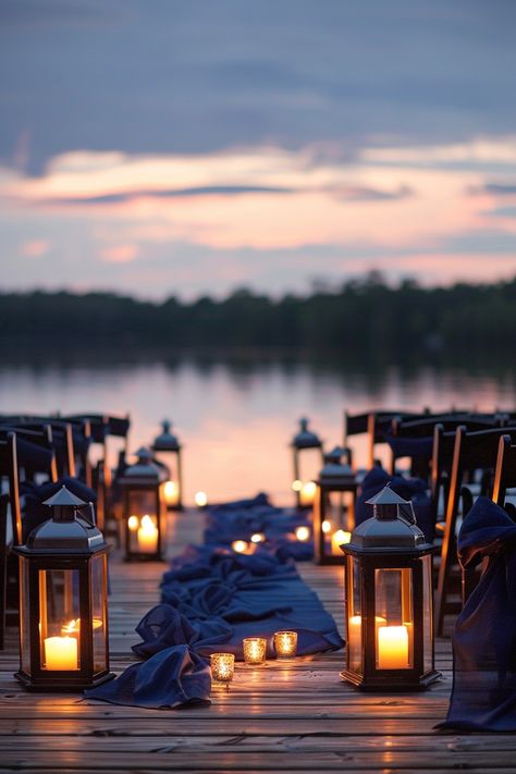 Dive into the romance of a lakeside wedding as dusk sets in 🌅. Envision serene waters, a pier adorned with glowing lanterns, and the allure of a symmetrical sea of chairs with chic navy sashes. Your dreamy nuptials await amidst nature's grandeur. ✨ #WeddingInspiration #LakesideWedding #TwilightWedding #OutdoorWedding #ElegantDecor #NavyBlueWedding #WeddingChairs #WeddingPlanning Over The Water Wedding, Lake Dock Wedding Ceremony, Lakeside Elopement, Dockside Wedding, Dock Wedding, Twilight Wedding, Lake Dock, Woodsy Wedding, Water Wedding