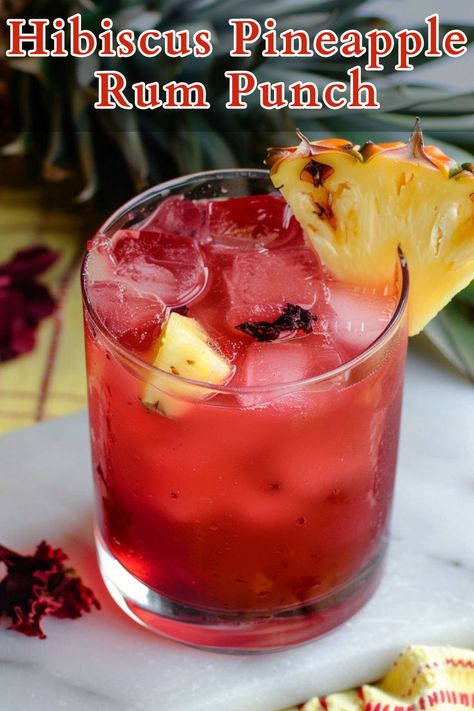 Hibiscus Pineapple Rum Punch is a refreshing and vibrant cocktail that combines the tartness of hibiscus tea with the sweetness of pineapple juice, balanced by the deep flavor of rum and a touch of grenadine for added sweetness and color. Pineapple Rum Punch, Summer Rum Cocktails, Dark Rum Cocktails, Rum Cocktails Easy, Hibiscus Cocktail, Cocktails To Make At Home, Summer Drink Cocktails, Rum Cocktail Recipes, Pineapple Rum