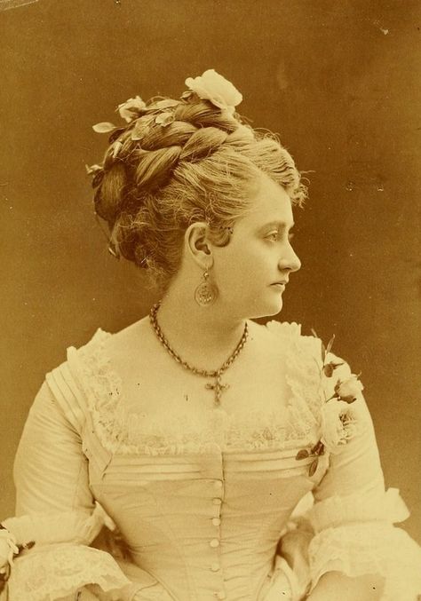 A beautiful Victorian lady wearing a large braided updo, 1874, jewelry cross necklace earrings antique x 1870s Hair, 1800s Hairstyles, Historical Hairstyles, Victorian Photography, Victorian Hair, 1870s Fashion, Victorian Portraits, Victorian Hairstyles, Old Portraits