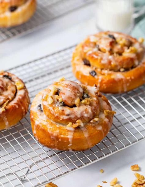 Homemade cinnamon rolls on a wire rack topping with raisins and white icing. Breakfast Cinnamon Rolls, Breakfast Cinnamon, The Cozy Cook, Cozy Cook, Cinnamon Roll Recipe Homemade, Thanksgiving Breakfast, Cinnamon Roll Dough, Best Cinnamon Rolls, Homemade Cinnamon Rolls