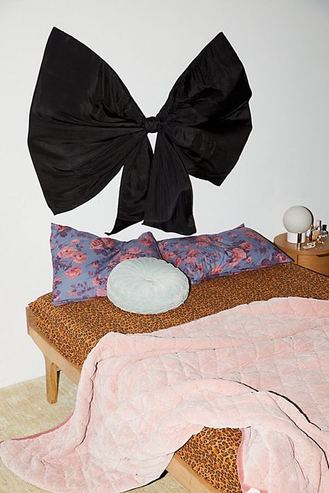 Wrap up your sleep sanctuary with this wall mount headboard featuring an oversized silky bow. This floating headboard is perfect for dressing up your bed or creating uniquely femme wall displays. Available exclusively at Urban Outfitters. Features Bow Upholstered Headboard from UO Home Floating headboard in an oversized bow silhouette Upholstered allover in silky viscose Made to order just for you Ready to hang with D-rings at the back Versatile - use it as a wall mount headboard or as wall décor Best fit for Full & Queen beds Arrives fully assembled UO exclusive Content + Care Arrives fully assembled Silk viscose, cotton canvas, sheeting and acrylic sheet Professional cleaning recommended Imported Size Dimensions: 57" l x 3" w x 46" h Weight: 11.5 lbs Shipping package dimensions: 51" l x Stick On Headboard, Girly Headboard, Wall Mount Headboard, Floating Headboard, Bow Silhouette, Sweet Room, Iron Headboard, Wall Mounted Headboards, Above Bed Art