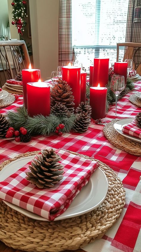 Festive Christmas table with red candles, pine cones, and gingham napkins on a red and white plaid tablecloth. Red White Christmas Table Setting, Red White Table Setting, Christmas Dining Room Table Decor, Christmas Dining Room Table, Red Pillar Candles, Red And White Christmas Decor, White Christmas Decor Ideas, Winter Table Decor, White Table Settings