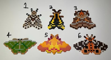 Different moth species turned into perler beads! These little guys make for excellent wall decorations and magnets!  Each item is made to order so items may appear differently than pictured.   Each item is ironed and fused in order to guarantee stability. One side is ironed "flat" while the other side is left "open". If you would like either both sides left "open" or "flat" you can put it in the personalization box!  If you have any questions for us please feel free to reach out! Thank you very Lunar Moth Pixel Art, Perler Beads Decor, Over The Garden Wall Perler Beads, Perler Bead Bugs, Perler Bead Moth, Moth Perler Beads, Peeler Bead Designs, Cat Perler Beads, Moth Insect