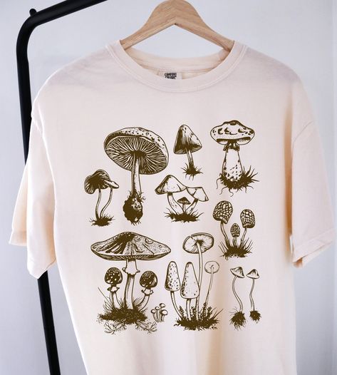 Vintage Mushroom Shirt ⭐ Welcome to K & K Custom Tees! ⭐  - Indulge in pure comfort with our Comfort Colors Shirt. Soft, relaxed, and available in a variety of colors! ⭐SHIRT DETAILS⭐  -High Quality fabric  -100% ring-spun US cotton -Designed and printed in the USA  ⭐ PLEASE NOTE ⭐ -For an oversized look, we suggest to size up 1-2 sizes. These shirts run like standard unisex tees. Please see size chart for a more fitted look!  -Colors may vary based on your monitor or screen display! ⭐CARE INSTR Cottage Core Tshirt, Cottagecore Store, Nils Style, Bleach Painting, Mushroom Tshirt, Screen Printed Shirts, Mushroom T Shirt, Mushroom Shirt, Shirt Inspiration