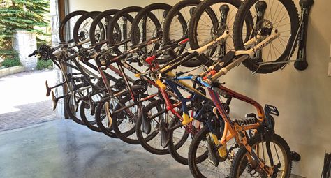 Many bikes hanging off the wall with Steady Rack bike storage in West Vancouver. Hanging From Ceiling, Bike Rack Garage, Bike Storage Garage, Monkey Bar, Toy Barn, Bicycle Rack, West Vancouver, Monkey Bars, North Vancouver