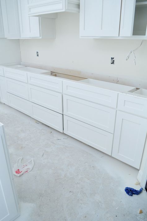 White kitchen with decorative vent hood and large island. Alabaster by Sherwin-Williams in a matte sheen for walls. | via monicawantsit.com Alabaster Walls With White Cabinets, Pure White Kitchen Cabinets, Kitchen Paint Color Inspiration, Update Walls, Alabaster Walls, White Kitchen Splashback Ideas, White Ceiling Paint, Small Hanging Lights, Hanging Wood Shelves