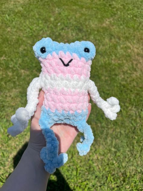 Made to order. Handmade crochet trans pride frog plush! Will deliver in discrete packaging  Made with 100% Polyester Chenille Yarn, Polyfill, and Safety eyes Warning safety eyes may be a choking hazard for young children  Size: Around 7 1/2" tall and 3" wide Trans Plushie, Trans Crochet Ideas, Trans Crochet, Pride Frog, Leggy Frog, Frog Plush, Chenille Yarn, Trans Pride, Safety Eyes