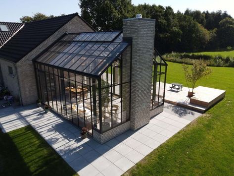 Orangery as an extension of living room - Drivadan Fireplace In Orangery, Green House Extension, Modern Glass Greenhouse, Victorian Orangery Extension, Glass Extension House, Orangeries Extension, Glass House Extension, Modern Orangery Extension, Enclosed Garden Structures