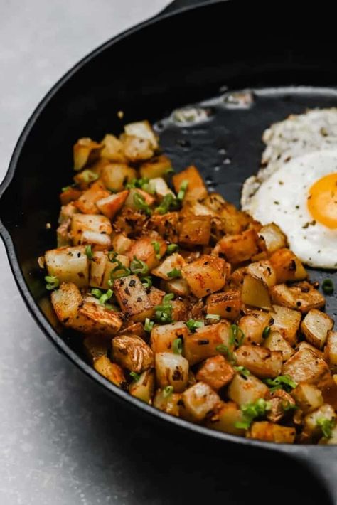 When you're craving diner-style breakfast potatoes, make these fried potatoes and onions! Parboil the potatoes, then get 'em all crispy in a cast iron skillet. Season with garlic, paprika, then serve with a couple of fried eggs for the complete diner experience. Brunch goals at home! #wellseasonedstudio #breakfastpotatoes #panfried #potatoes #skilletpotatoes Pan Fried Potatoes And Onions, Fried Breakfast Potatoes, Fried Potatoes And Onions, Home Fried Potatoes, Breakfast Potatoes Skillet, Crispy Breakfast Potatoes, Pan Fried Potatoes, Eggs Potatoes, Potato Breakfast Recipes