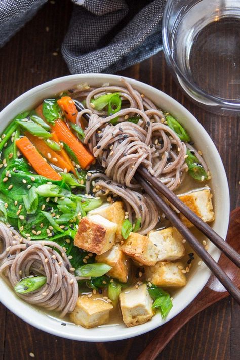 Slurpable noodles, hearty tofu, and vibrant veggies go into this Asian-inspired vegan soba noodle soup! Super cozy and ready to serve in under 30 minutes, this meal-worthy vegetarian soup is perfect for cold winter days. #veganrecipes #tofu #sobanoodles #soup #misosoup #vegetarian #meatlessmonday Vegetarian Noodle Bowls, Vegetarian Miso Soup, Soba Noodle Recipe, Soba Noodle Soup, Soba Noodles Soup, Udon Noodles Recipe, Soba Noodles Recipe, Vegetarian Noodles, Soba Noodle