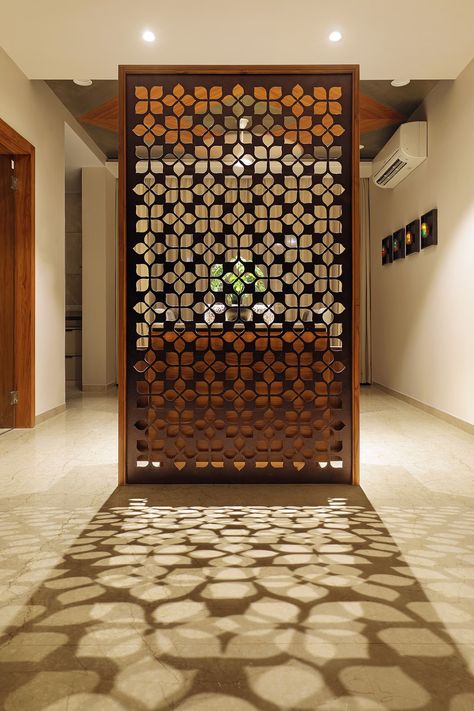 Floral Pattern Inspires Apartment Interiors | Studio 7 - The Architects Diary Wooden Screen Door, Wall Partition Design, Wall Partition, Wooden Partitions, Jaali Design, Furniture Design Inspiration, Divider Design, Pooja Room Door Design, Wooden Screen