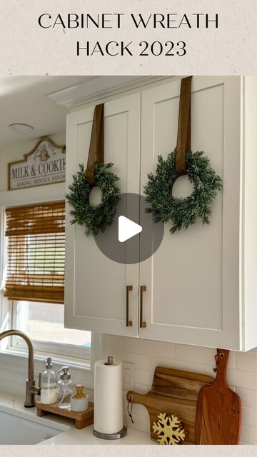 Christmas Wreaths Cabinets, Wreath For Cabinet Doors, Hanging Small Wreaths On Cabinets, Christmas Wreath In Kitchen, Christmas Kitchen Wreaths, Hanging Wreaths With Ribbon, Top Of Cabinets Christmas Decorations, Kitchen Cabinet Christmas Wreath, Hang Wreaths On Cabinets